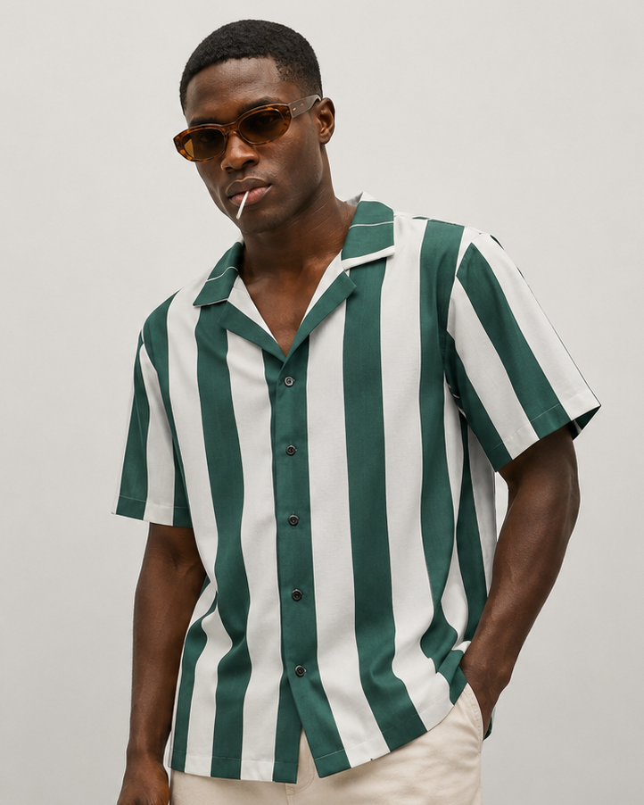 Man wearing a green and white striped shirt against a plain background