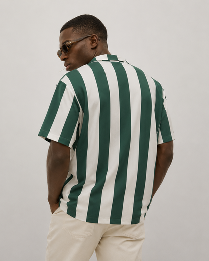 Man wearing a green and white striped shirt against a plain background