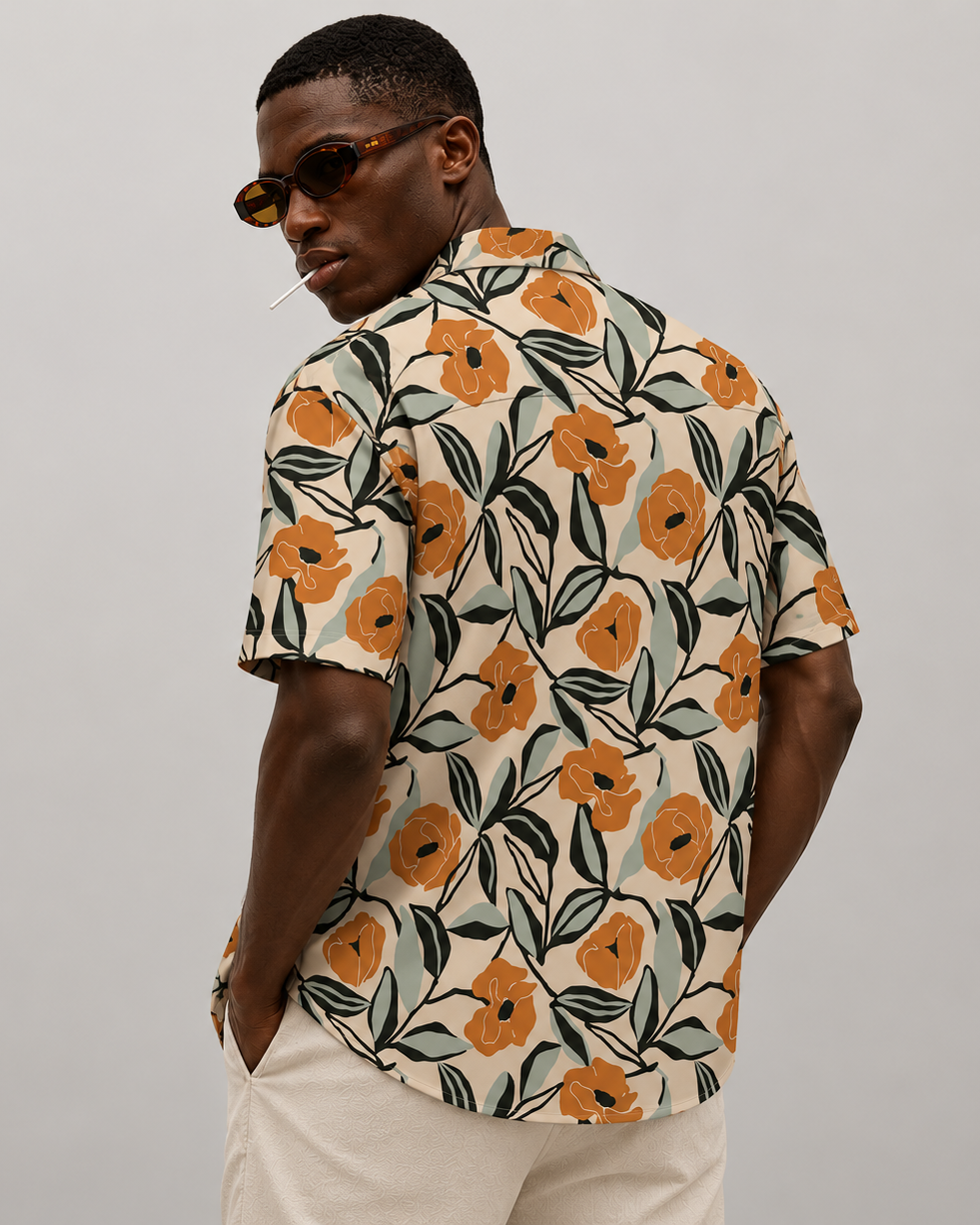 Man wearing a floral patterned shirt against a plain background