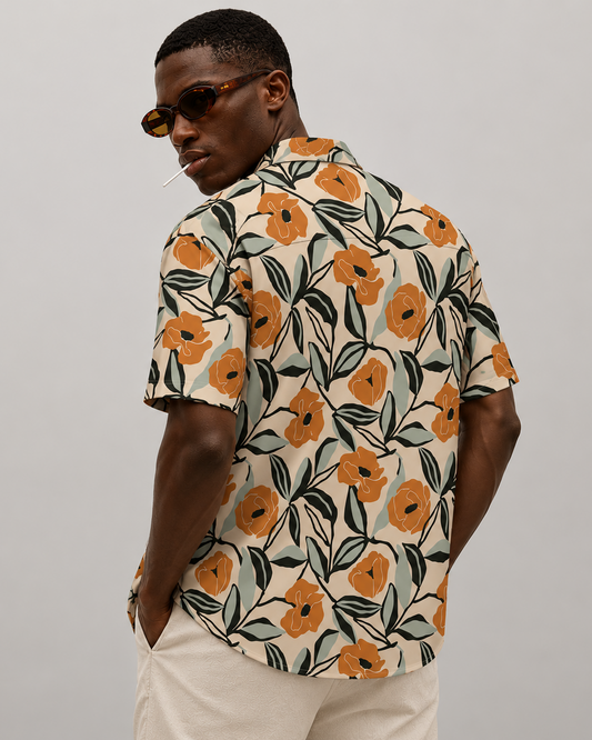 Man wearing a floral patterned shirt against a plain background