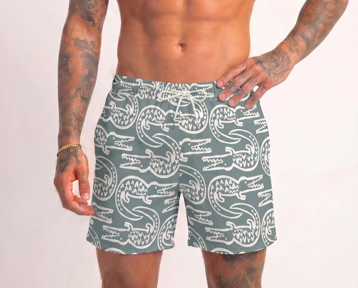 Person wearing green swim shorts with white crocodile pattern on a plain background
