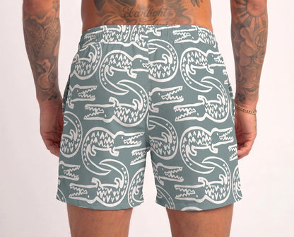 Person wearing shorts with white crocodile pattern on a light gray background